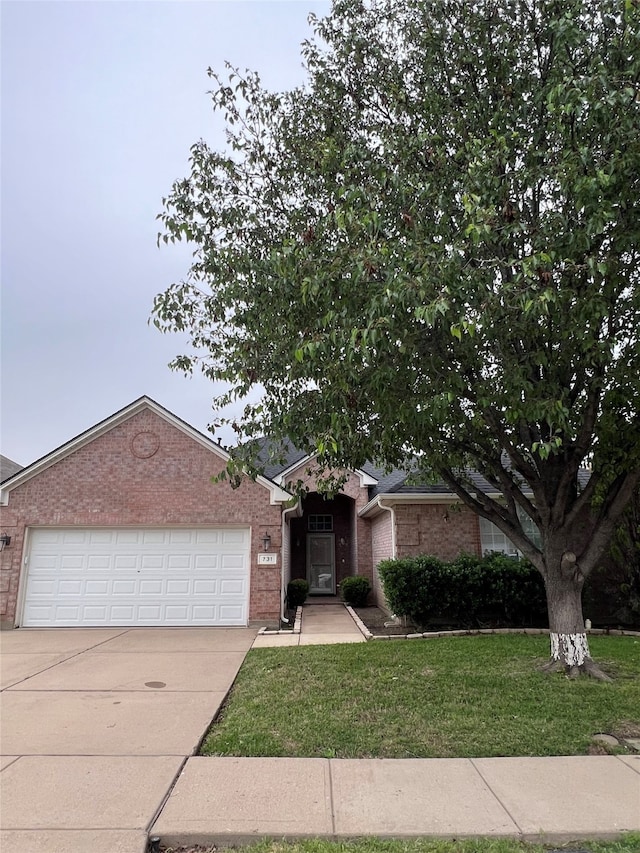 ranch-style house featuring a garage and a front yard