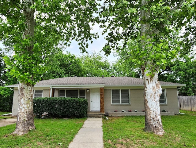 ranch-style home featuring a front yard