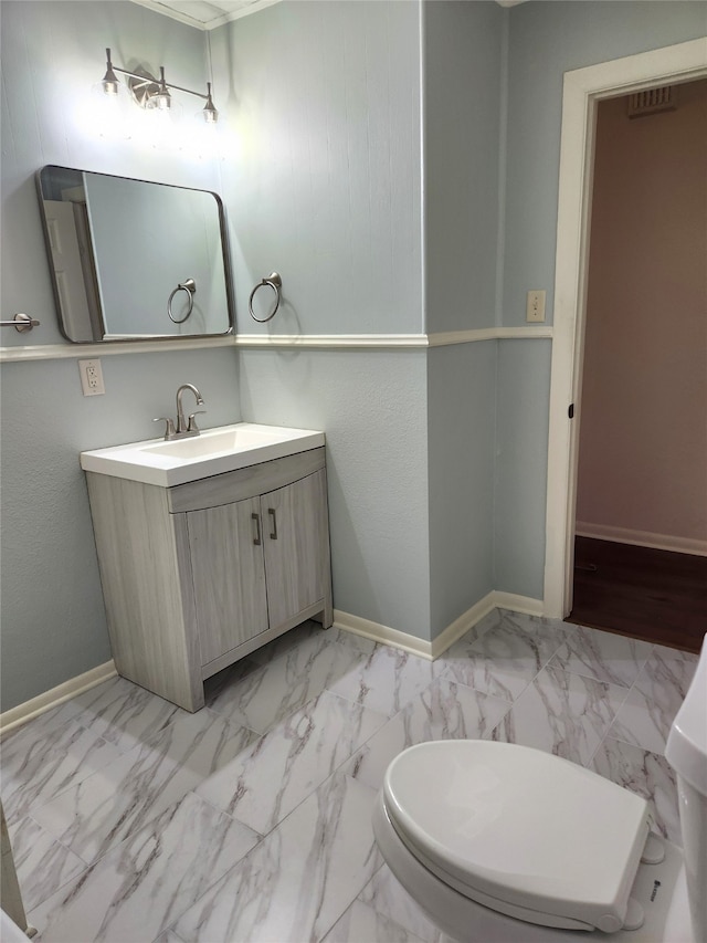 bathroom featuring vanity, toilet, and tile flooring