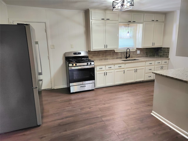 kitchen with appliances with stainless steel finishes, backsplash, dark hardwood / wood-style floors, light stone counters, and sink