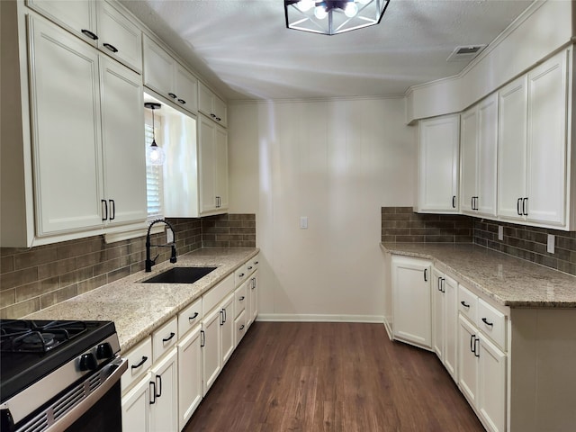 kitchen featuring white cabinets, sink, tasteful backsplash, and dark hardwood / wood-style floors