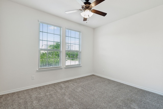 carpeted spare room featuring ceiling fan