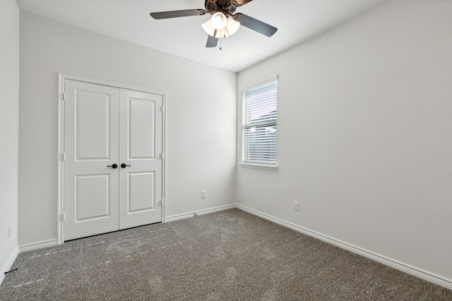 unfurnished bedroom with ceiling fan, a closet, and carpet flooring