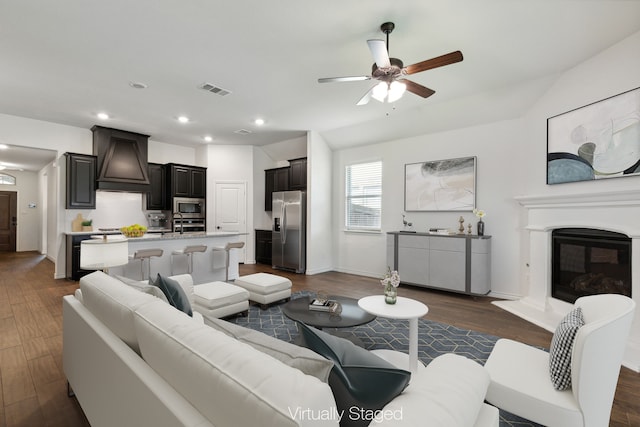 living room with dark hardwood / wood-style flooring and ceiling fan