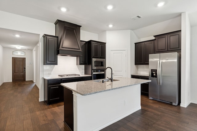 kitchen with dark hardwood / wood-style floors, stainless steel appliances, custom exhaust hood, and tasteful backsplash