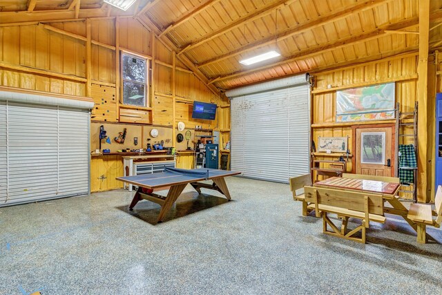 recreation room with wood walls, beam ceiling, high vaulted ceiling, and wooden ceiling