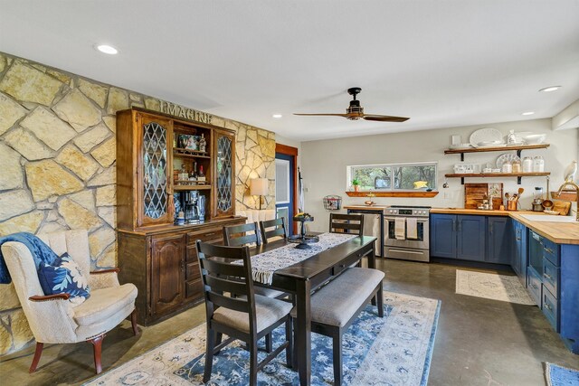 dining room featuring sink and ceiling fan