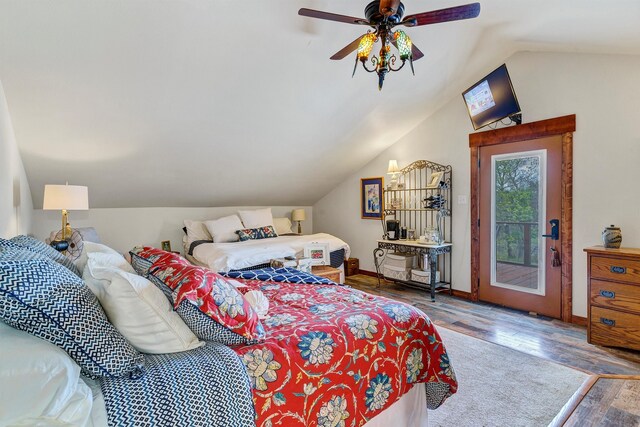 bedroom featuring vaulted ceiling, hardwood / wood-style floors, ceiling fan, and access to exterior