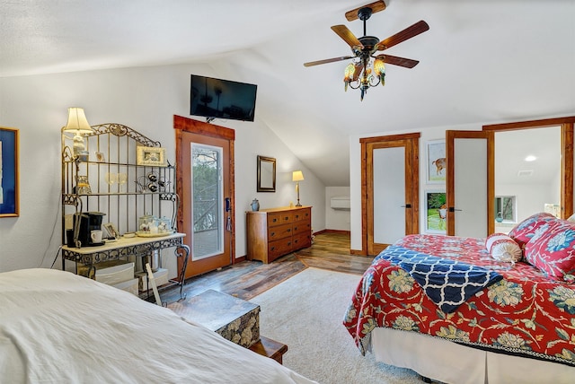 bedroom with hardwood / wood-style floors, vaulted ceiling, ceiling fan, and access to outside