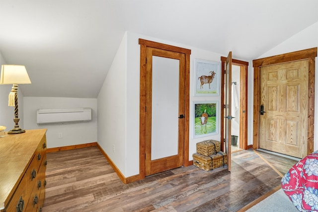 interior space featuring an AC wall unit, dark wood-type flooring, and lofted ceiling