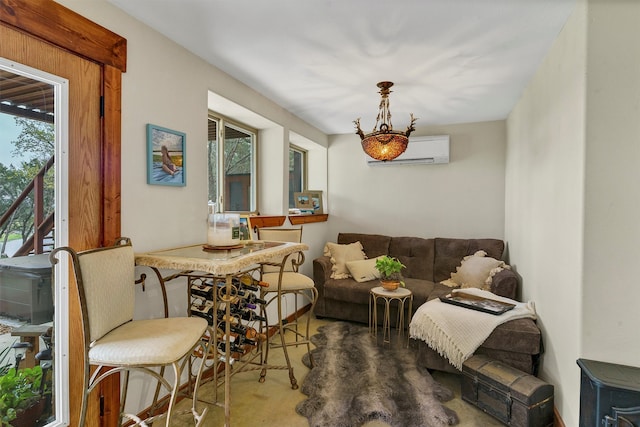 living room with a wall unit AC and a healthy amount of sunlight