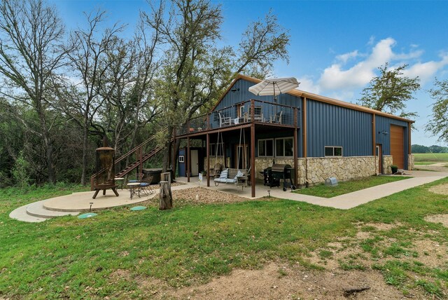 rear view of house featuring a patio area, a yard, and an outdoor hangout area