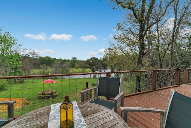 wooden terrace featuring a lawn