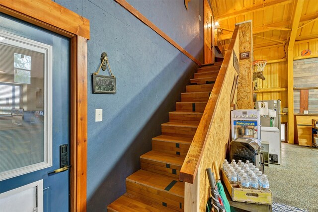 stairway featuring carpet flooring