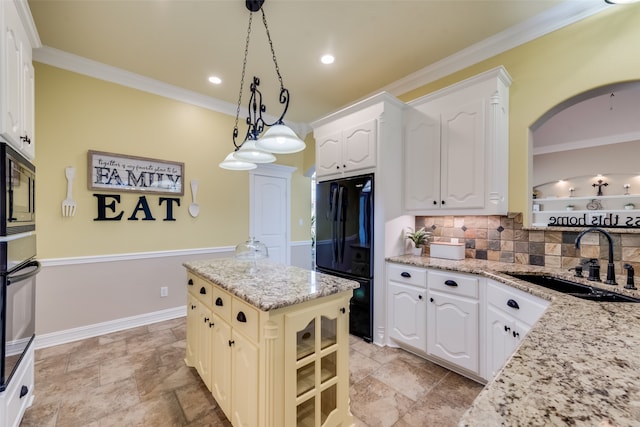 kitchen featuring a center island, stainless steel microwave, backsplash, sink, and light tile flooring