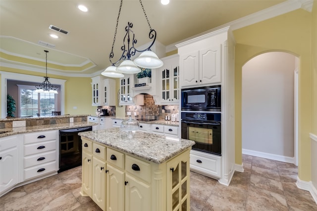 kitchen featuring a center island, black appliances, pendant lighting, tasteful backsplash, and light tile flooring