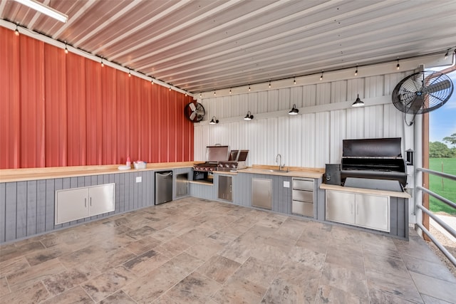 interior space with a healthy amount of sunlight, sink, light tile flooring, and gray cabinets