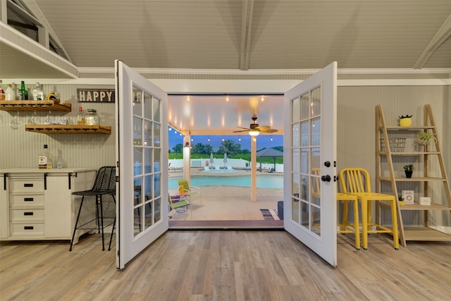 doorway to outside featuring french doors, ceiling fan, vaulted ceiling, and light hardwood / wood-style flooring