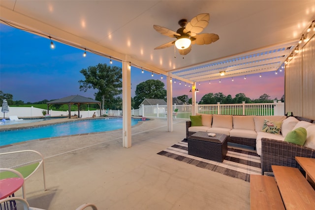 view of swimming pool with outdoor lounge area, a patio, and ceiling fan