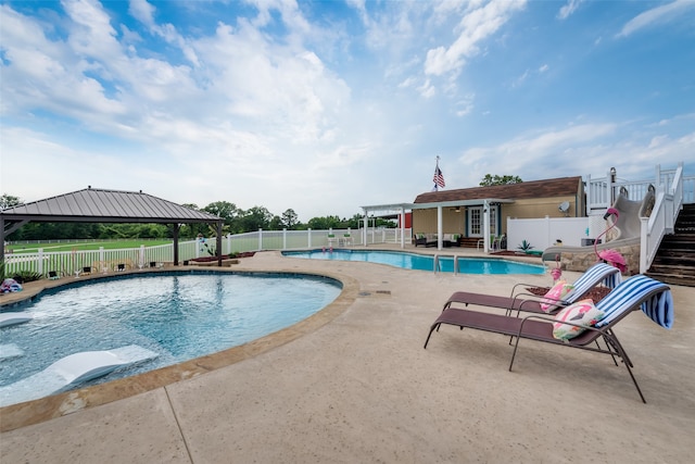 view of swimming pool with a patio and a gazebo