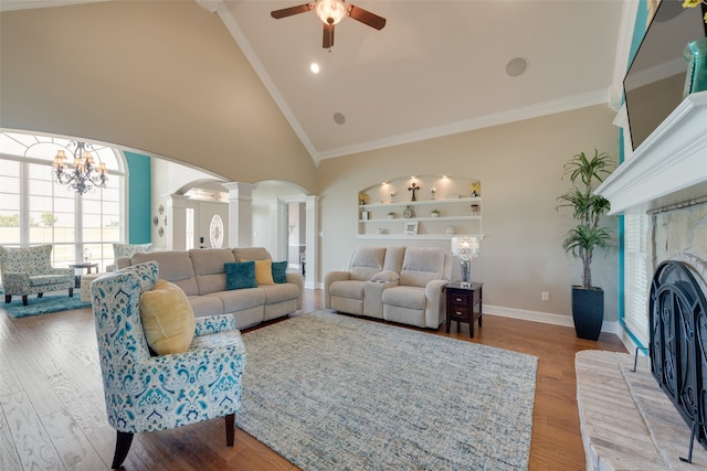 living room featuring hardwood / wood-style floors, ornamental molding, and ceiling fan with notable chandelier