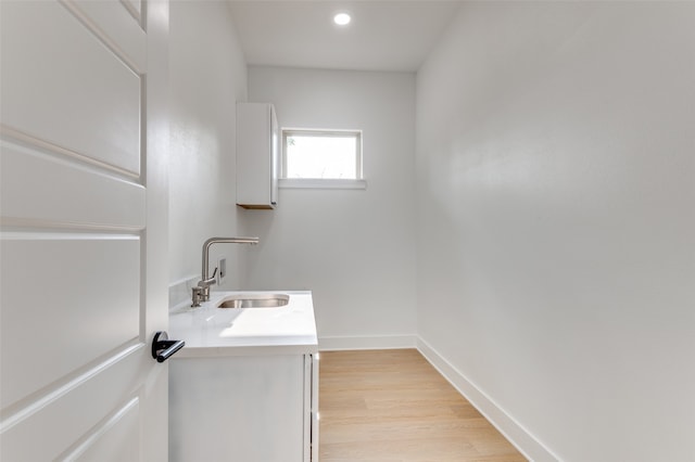 bathroom with wood-type flooring and vanity