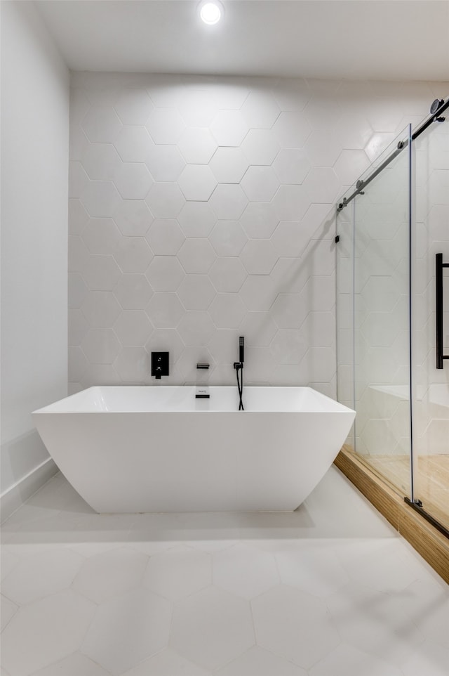 bathroom with walk in shower, tile walls, and tile floors