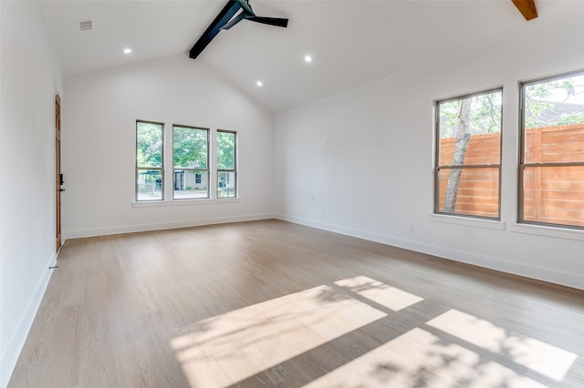 unfurnished room with high vaulted ceiling, beam ceiling, and light wood-type flooring