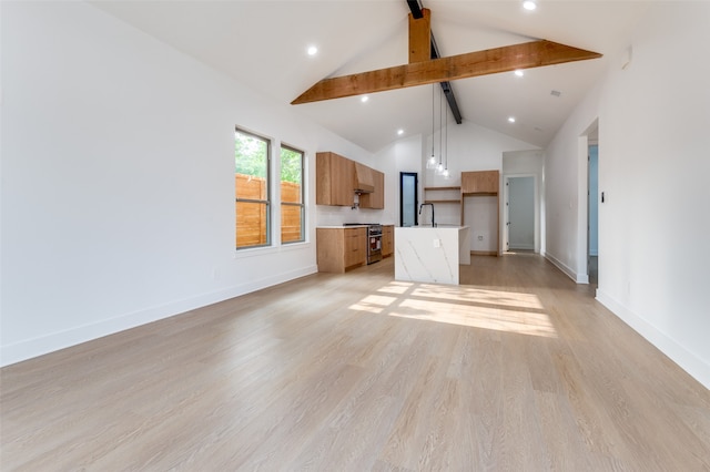 unfurnished living room with beamed ceiling, sink, light wood-type flooring, and high vaulted ceiling