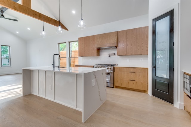 kitchen featuring ceiling fan, pendant lighting, stainless steel stove, and light wood-type flooring