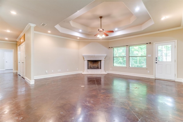 unfurnished living room featuring a raised ceiling, ceiling fan, and ornamental molding