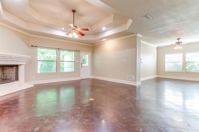 unfurnished living room with a fireplace, a raised ceiling, ceiling fan, and crown molding