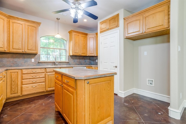 kitchen with tasteful backsplash, sink, pendant lighting, dark tile patterned flooring, and a center island