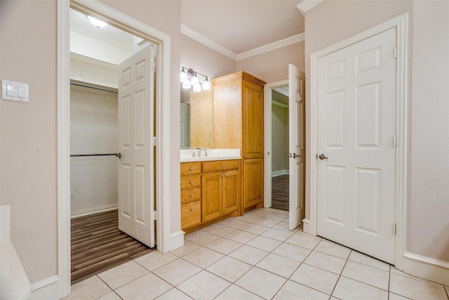 bathroom featuring vanity, wood-type flooring, and ornamental molding