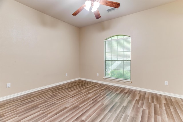 unfurnished room featuring ceiling fan and light wood-type flooring