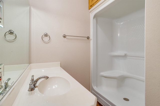 bathroom with vanity and walk in shower