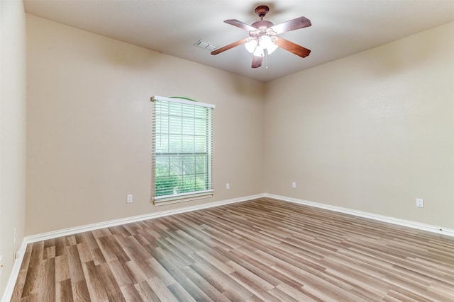 spare room featuring light wood-type flooring and ceiling fan