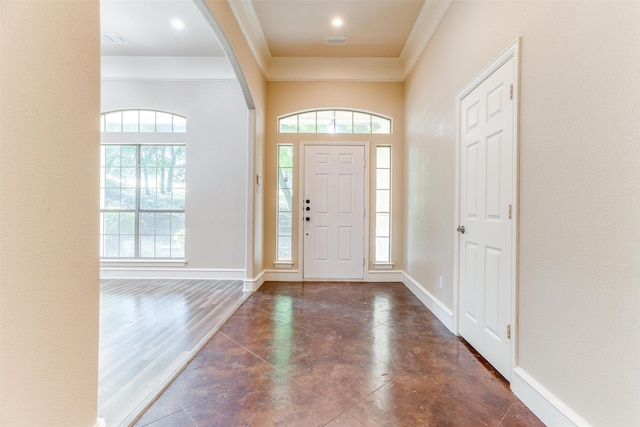 foyer featuring dark hardwood / wood-style floors and crown molding