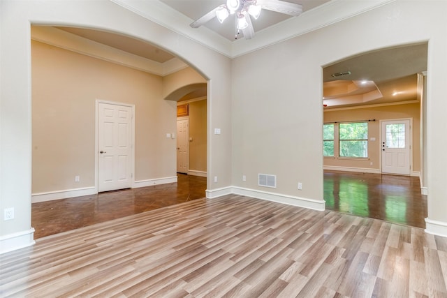 unfurnished room featuring crown molding, ceiling fan, and light wood-type flooring