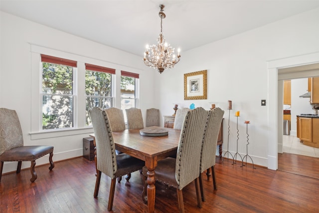 dining area with a chandelier and dark hardwood / wood-style floors