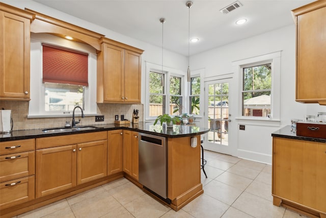 kitchen with pendant lighting, dishwasher, sink, tasteful backsplash, and kitchen peninsula