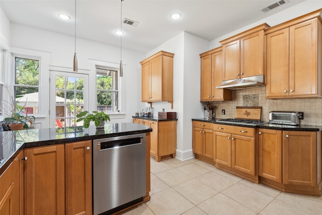 kitchen with stainless steel appliances, dark stone countertops, pendant lighting, decorative backsplash, and light tile patterned flooring