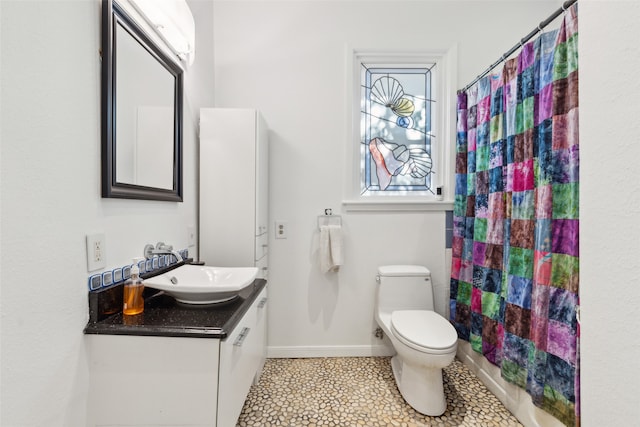 bathroom featuring tile patterned flooring, vanity, and toilet