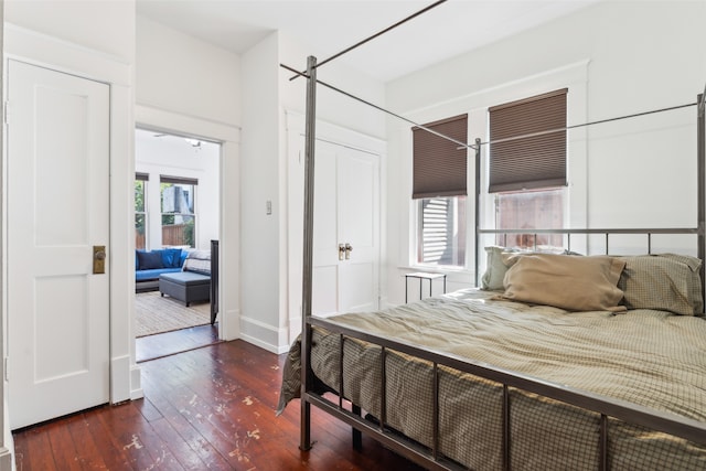 bedroom featuring dark hardwood / wood-style flooring and a closet