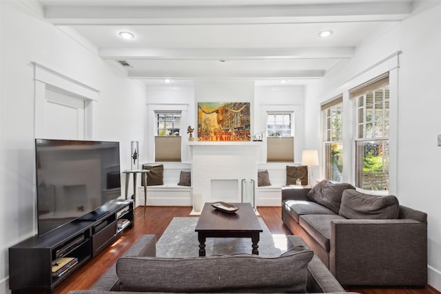 living room with dark hardwood / wood-style floors and beam ceiling