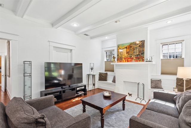 living room featuring a fireplace, wood-type flooring, and beam ceiling