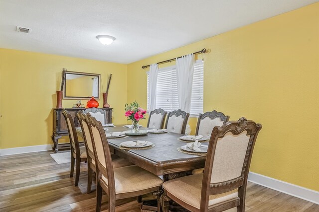 dining area with hardwood / wood-style floors