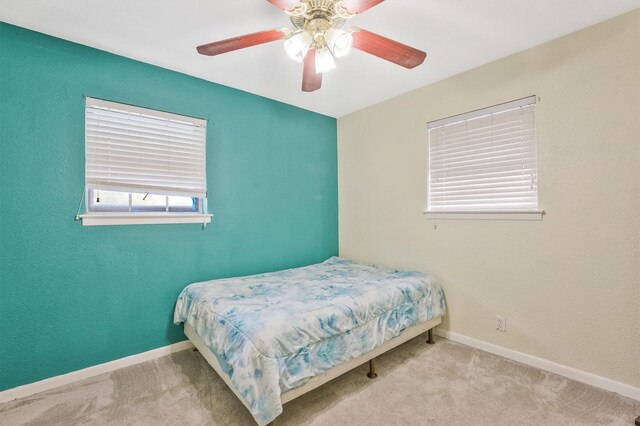 carpeted bedroom featuring ceiling fan