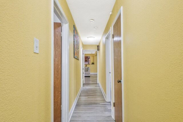 corridor featuring light wood-type flooring