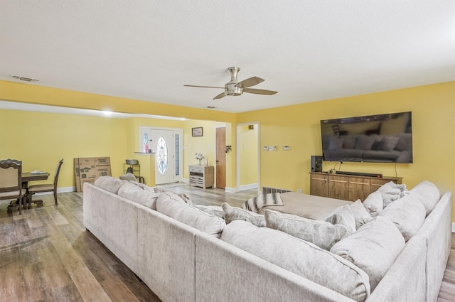 living room with hardwood / wood-style flooring and ceiling fan